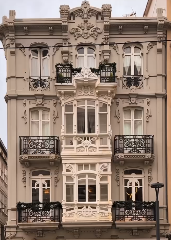 Cropped photo of the exterior of the top floor of an old stone building.